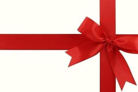 Red ribbon tied in a bow on a white background, forming a cross.
