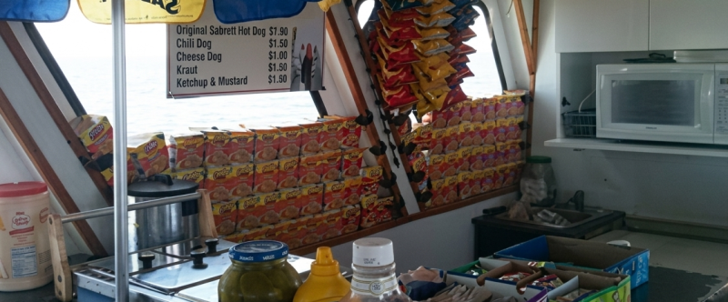 Snack bar with condiments, chips, menu, and microwave.